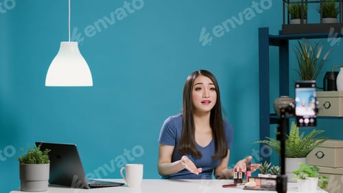 Preview: Young vlogger filming online video with makeup cosmetics