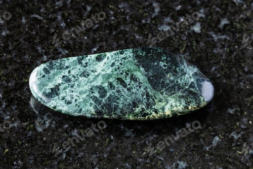 Preview: tumbled peridotitic komatiite rock on black