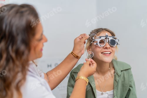 Preview: Female ophthalmologist adjusting the lens degree of a client