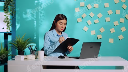 Preview: Businesswoman cross-checking data