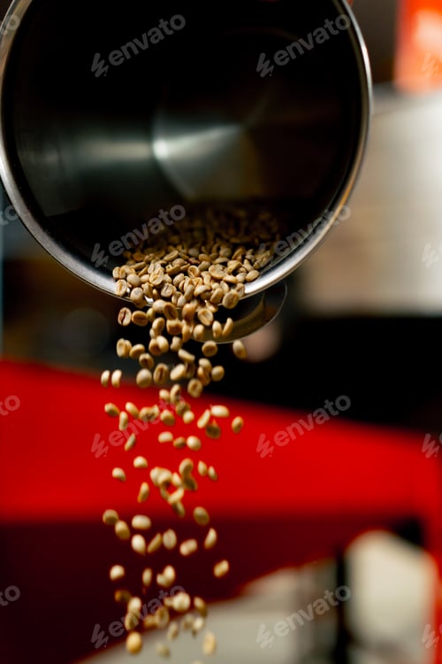 Preview: Close-up of coffee roasting factory in an iron bucket green coffee being poured onto the scales