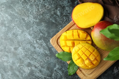 Preview: Tasty ripe mango fruit on black smokey table