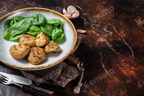Preview: Fish Cakes or Fish balls with tuna and spinach in a plate. Dark background. Top view