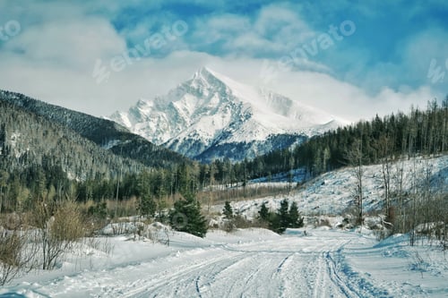 Preview: Snowy mountains, blue sky, blue background, beautiful winterland, rocky mountains, sunny day, road