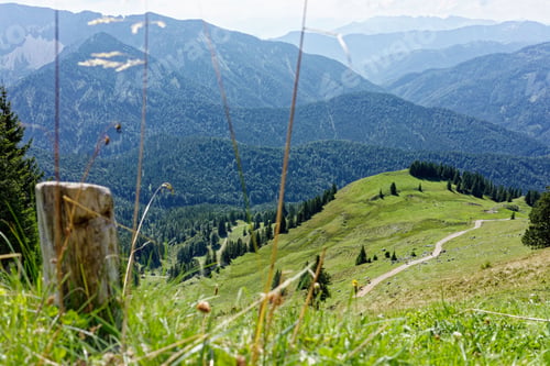Preview: Scenic green mountain landscape with winding path.