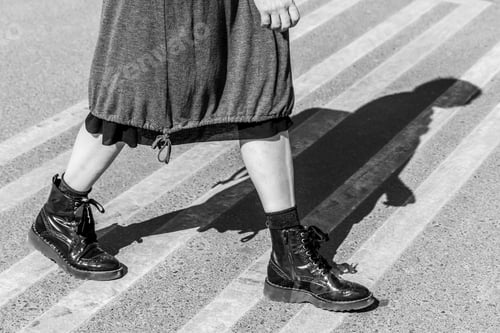 Preview: Stylish woman walking on a street