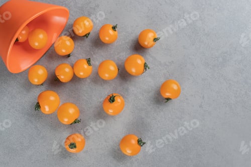 Preview: Yellow cherry tomatoes isolated on a concrete background