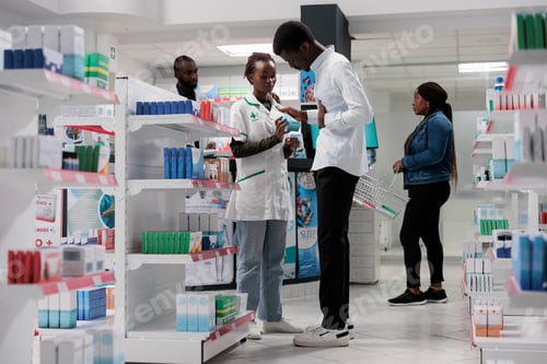 Preview: Customer buying stomachache medication, pharmacy consultant and buyer talking