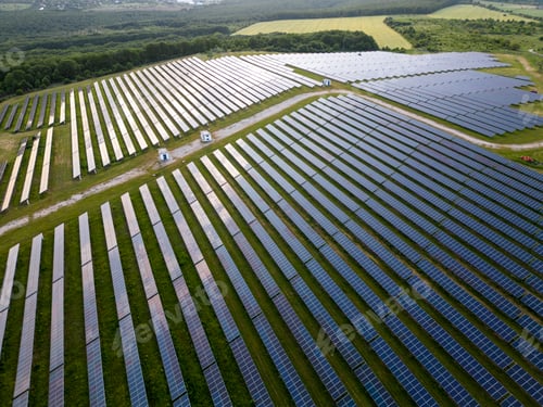 Preview: big solar power station on a green meadow aerial view