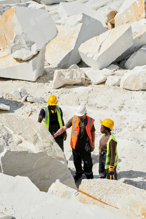 Preview: Group of quality control standing in front of huge white marble rock