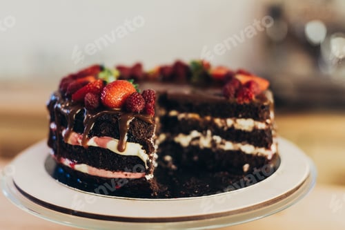 Preview: delicious homemade chocolate cake with fruits on a wooden table