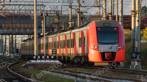 Preview: Modern intercity high speed train under the bridge on railroad at sunset