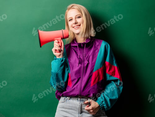 Preview: woman in 90s style punk jacket with loudspeaker on green background