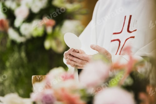 Preview: Priest consecrating the host during a celebration.