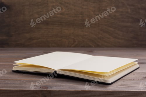 Preview: notepad or paper book at wooden table