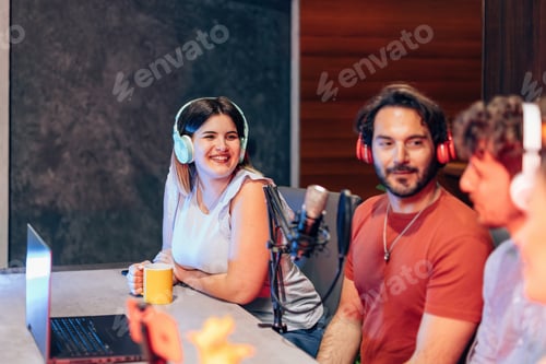 Preview: Radio hosts recording podcast in studio, using professional microphone and headphones