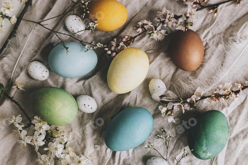 Preview: Stylish Easter eggs and cherry blossoms on rustic linen cloth flat lay. Happy Easter! Greeting card
