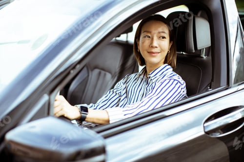 Preview: Korean woman in car smiling during daytime drive through city streets