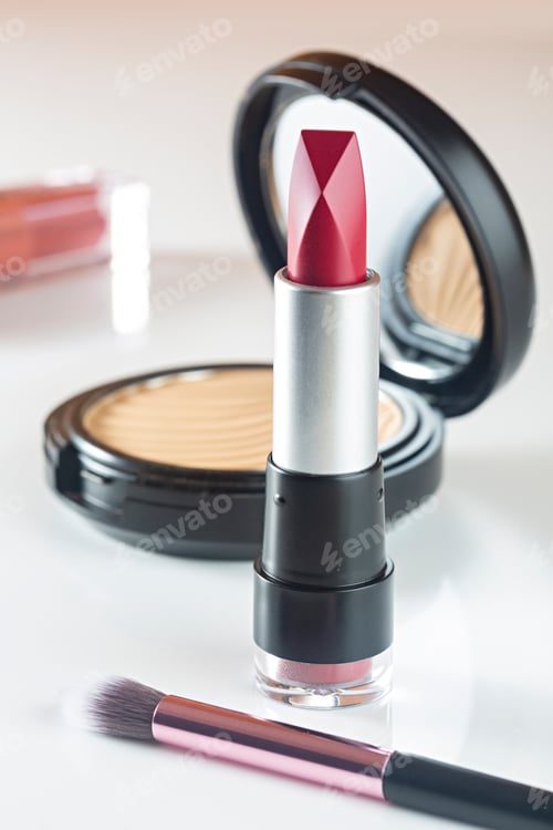 Preview: Cosmetic products lipstick, powder on white background.