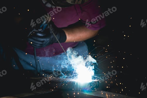 Preview: Industry worker welding iron pieces at work