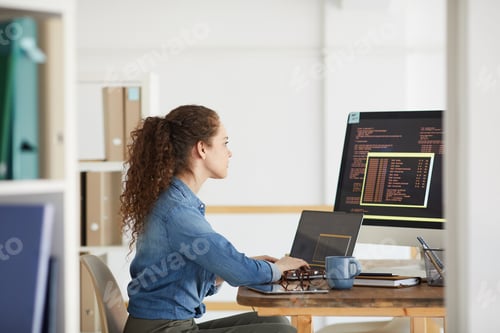 Preview: Young Woman Working in Software Development Studio