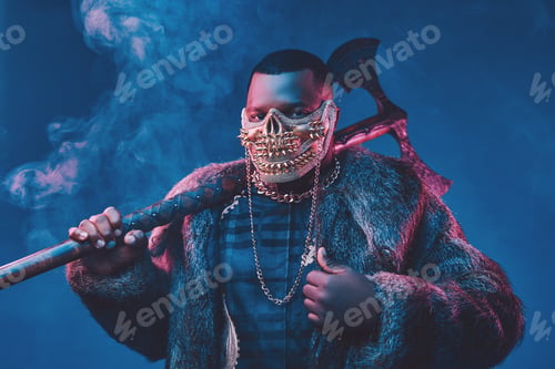 Preview: Evil african man with golden mask and huge axe