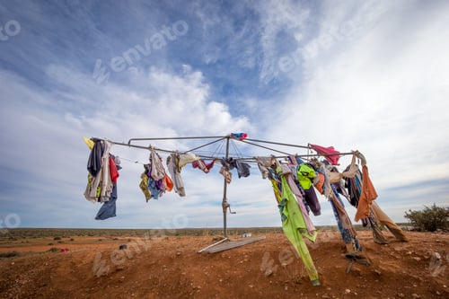 Preview: Closeup of the laundry drying on racks outdoors under a blue cloudy sky and sunlight