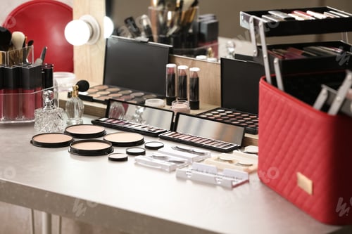 Preview: Different makeup products and accessories on dressing table in room interior