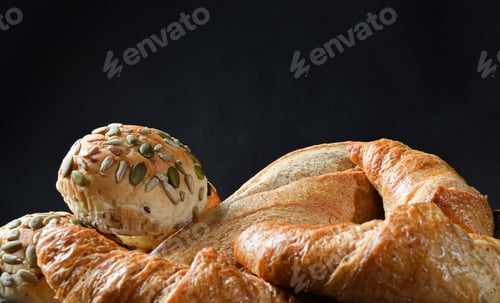 Preview: Plate of freshly-baked pastry rolls on a dark background
