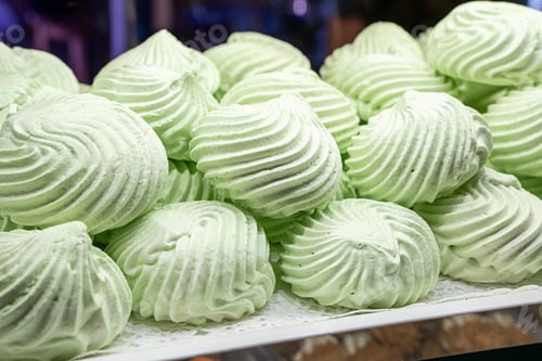 Preview: Fresh pistachio meringue cookies displayed light green swirled homemade sweet dessert pastry