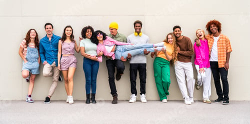 Preview: Happy playful multiethnic group of young friends bonding outdoors