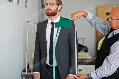 Preview: Tailor Measures a Jacket on a Young Man