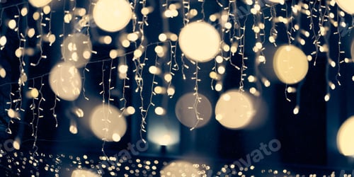 Preview: Pale yellow lights bokeh from christmas holiday garlands, blurred festive abstract background lights