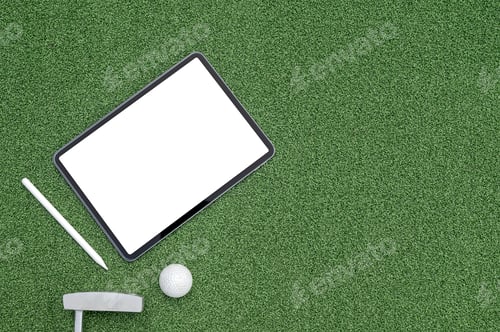 Preview: Top view tablet on green grass background.