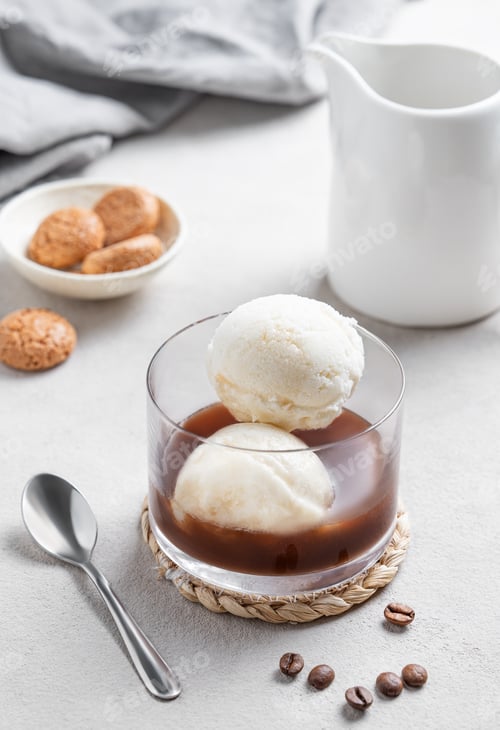 Preview: Affogato coffee with vanilla ice cream scoops and espresso in a glass on a light background