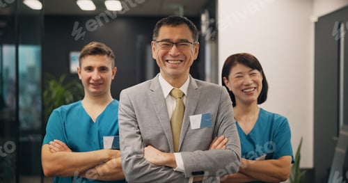 Preview: Portrait, doctors and investor with Japanese man and arms crossed in hospital for leadership, teamw