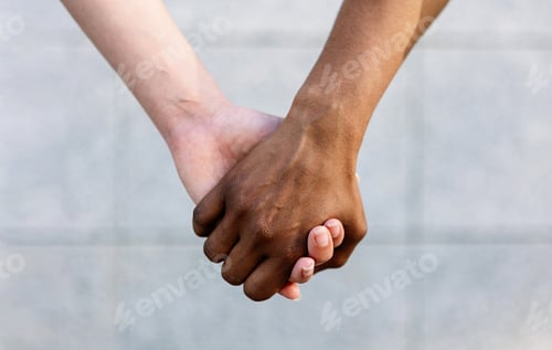 Preview: Close up shot of two diverse women holding hands showing unity and support