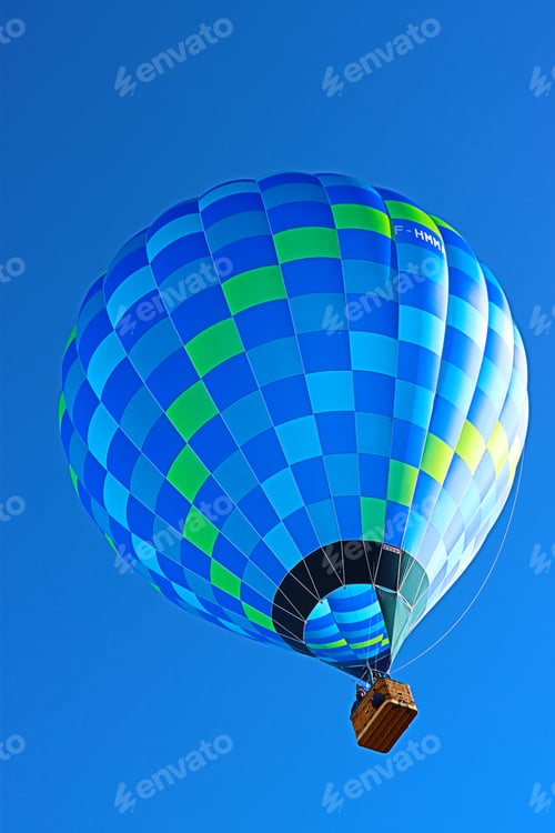 Preview: Vertical shot of a blue hot air balloon on a clear sky background