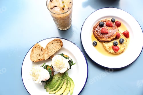 Preview: Brunch with pancakes, avocado, toast and poached eggs from above
