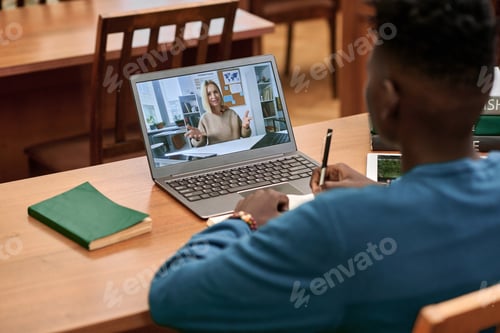 Preview: Student Attending Virtual Class in Library