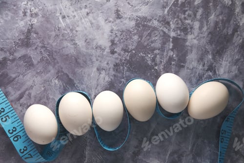 Preview: measurement tape and eggs on black background