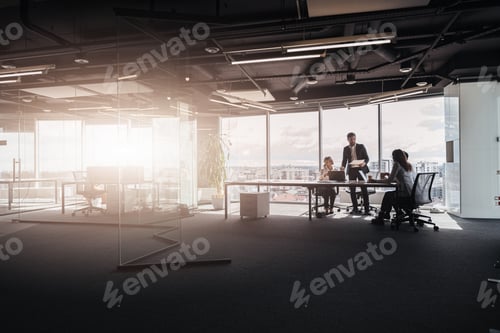 Preview: Team of young businessmen working and communicating together in office, people standing near table