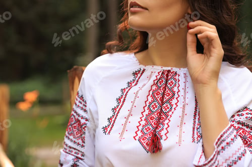 Preview: Woman in beautiful embroidered shirt outdoors, closeup. Ukrainian national clothes