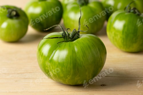 Preview: Whole fresh green zebra tomato close up