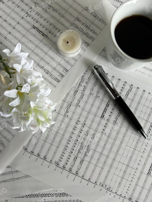 Preview: Overhead shot of music sheets with pen, coffee and hyacinth