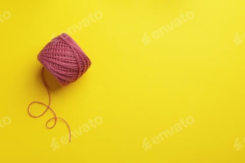 Preview: Clew of knitting threads on color background, top view with space for text. Sewing stuff