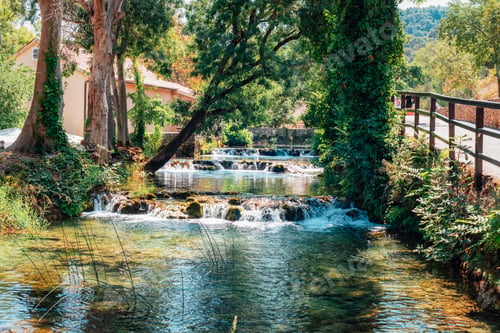 Preview: Small cascading waterfalls and clear river surrounded by trees. Nature, travel and relaxation