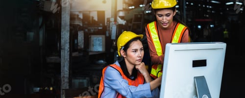 Preview: group of Asian engineer team wearing helmet and reflective vest in check and control on computer