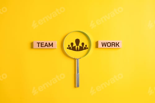 Preview: Teamwork word on wooden blocks with magnifying glass