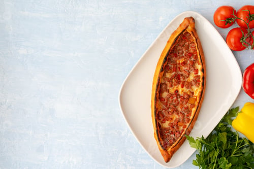 Preview: Turkish baked Pide bread on light blue wooden surface